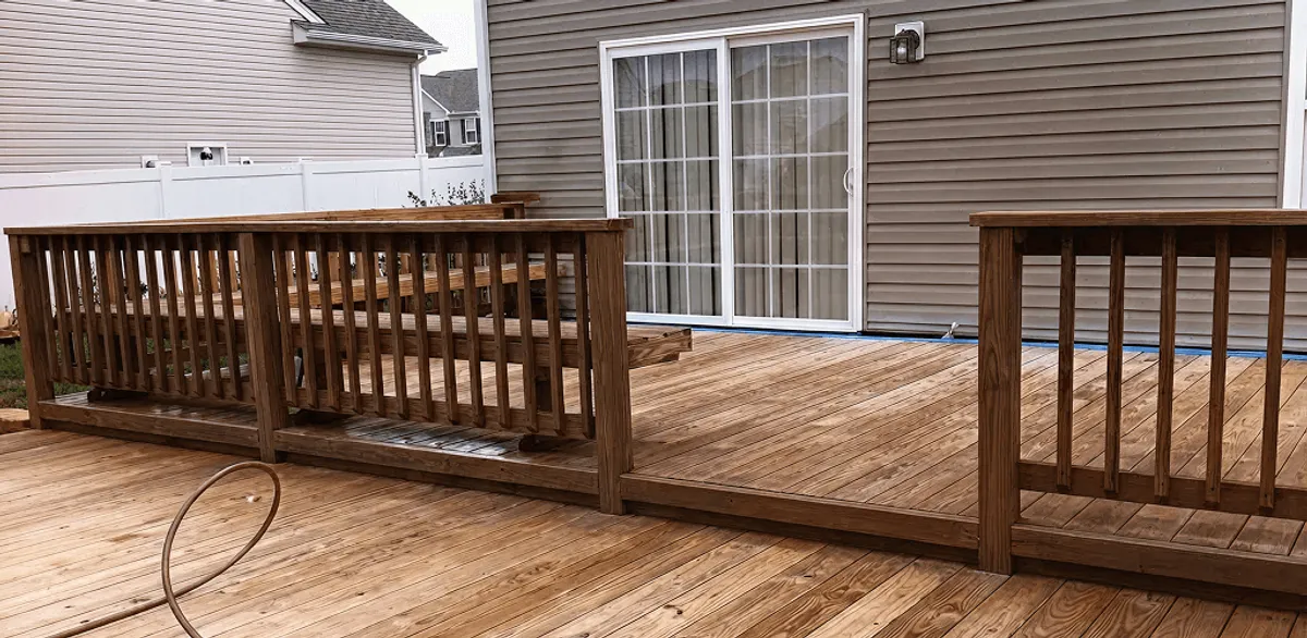 Deck sealing service protecting a backyard wood deck and railings in Henderson, NV