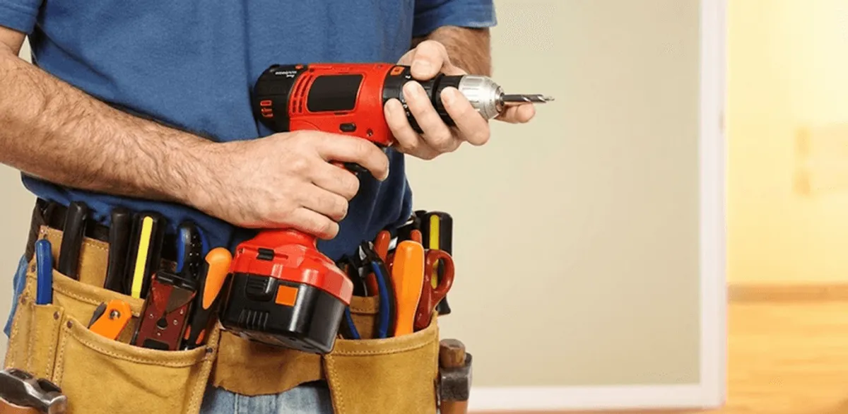 Handyman holding a power drill for home repairs and installations in Henderson, NV