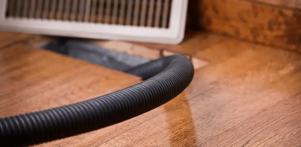 Air duct cleaning hose inserted into a floor vent for ductwork cleaning in Henderson, NV